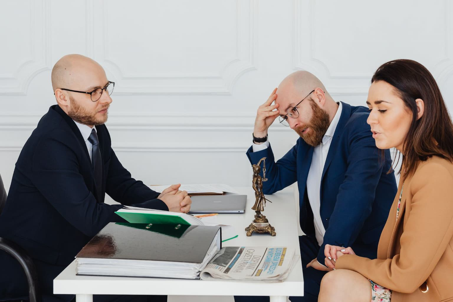 Lawyer advising couple on property documents during divorce