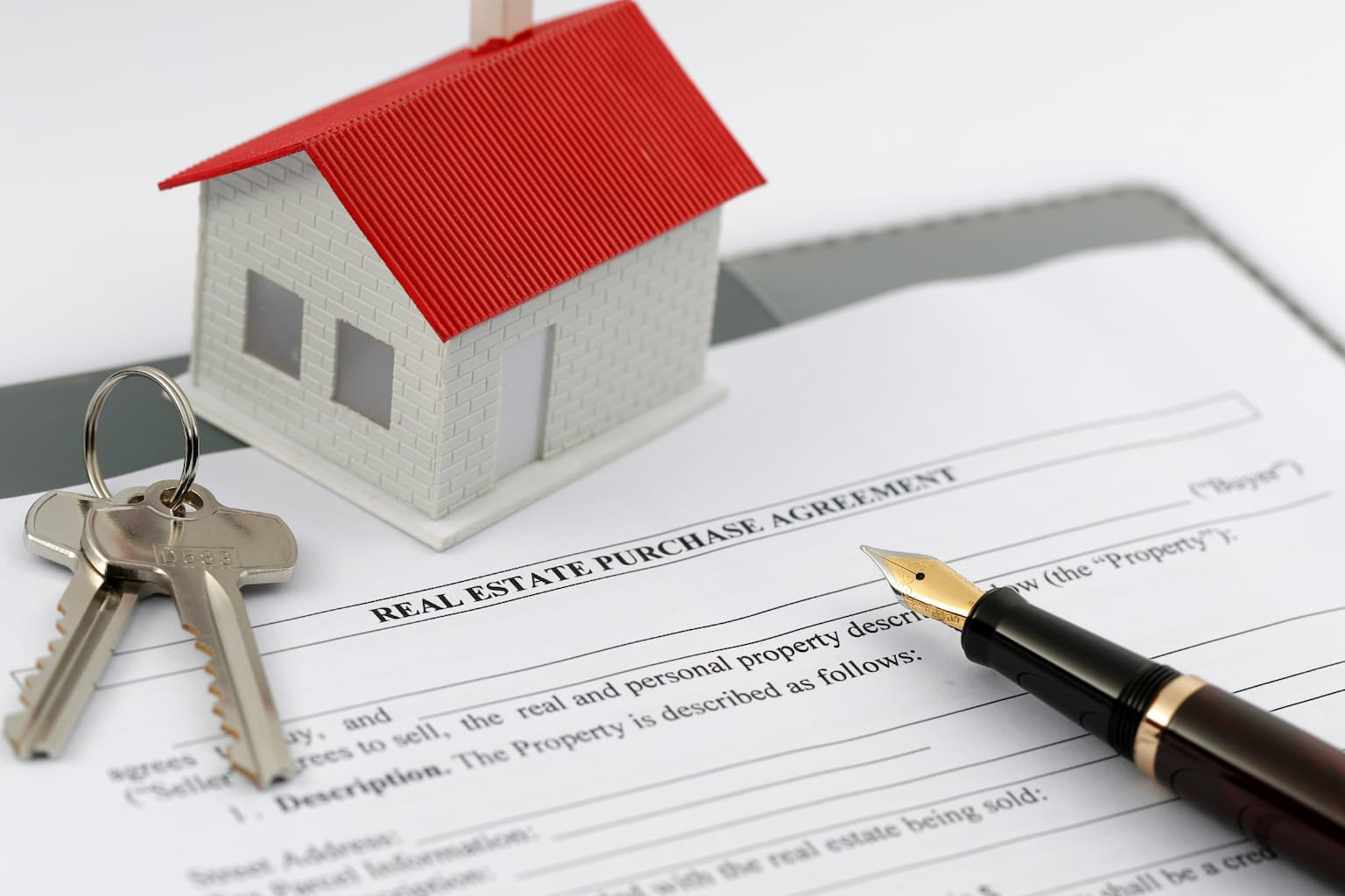 Legal real estate documents and keys on a desk