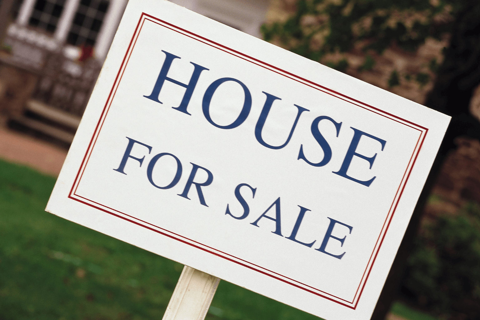 For sale sign in front of a rental home with tenants