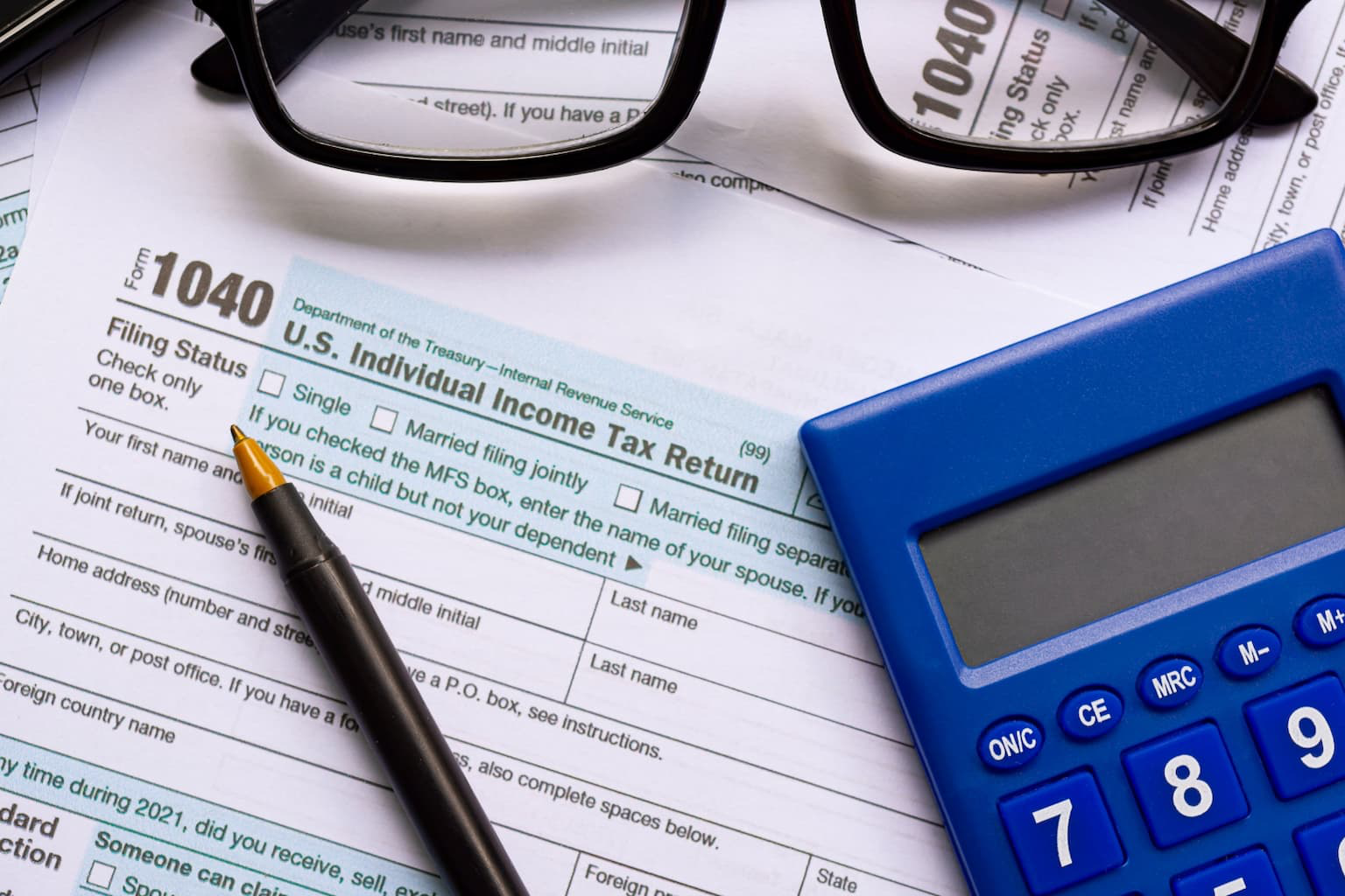 Tax paperwork and calculator during short sale in California