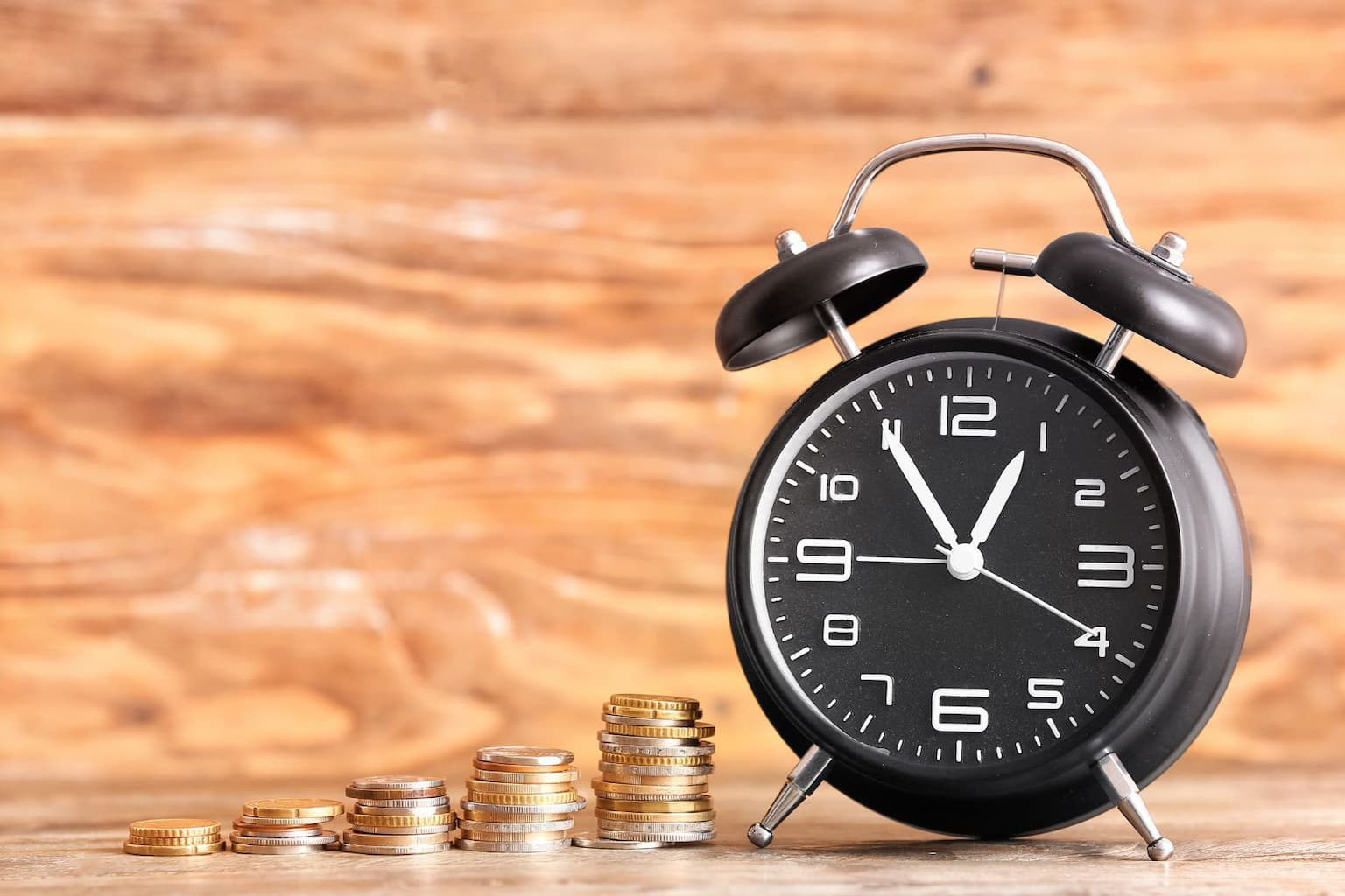 Time is money concept with clock and coins
