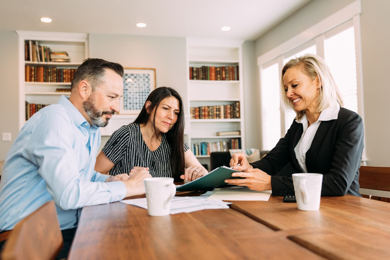 Tax advisor discussing inherited property sale with client at a desk