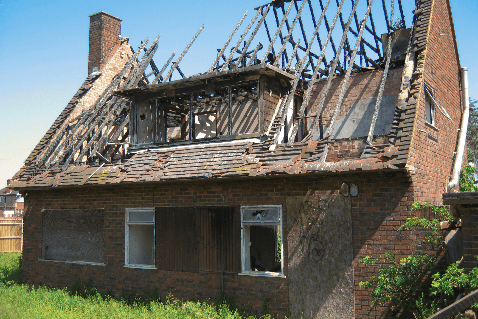 Front of a fire-damaged house with smoke stains