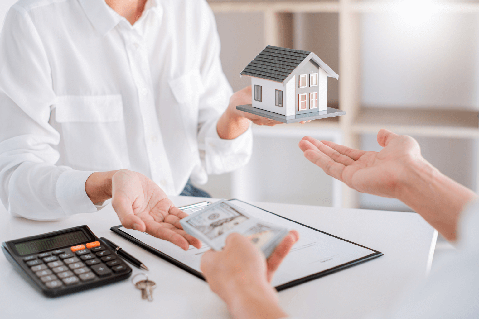 Handshake over house model and cash offer