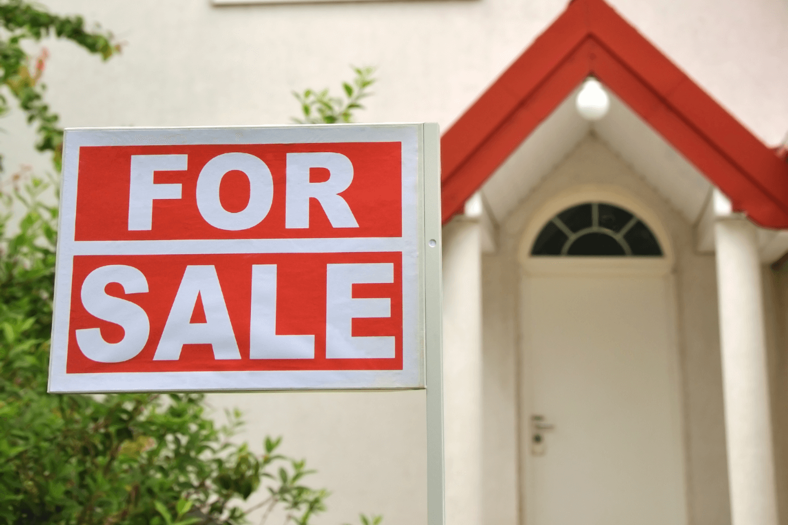 House for sale sign in front of a home
