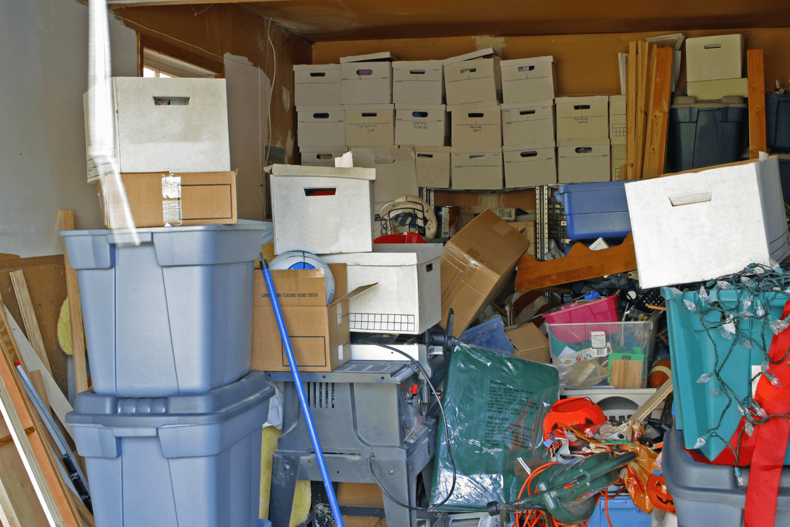 Cluttered living room in a hoarder house with stacked boxes