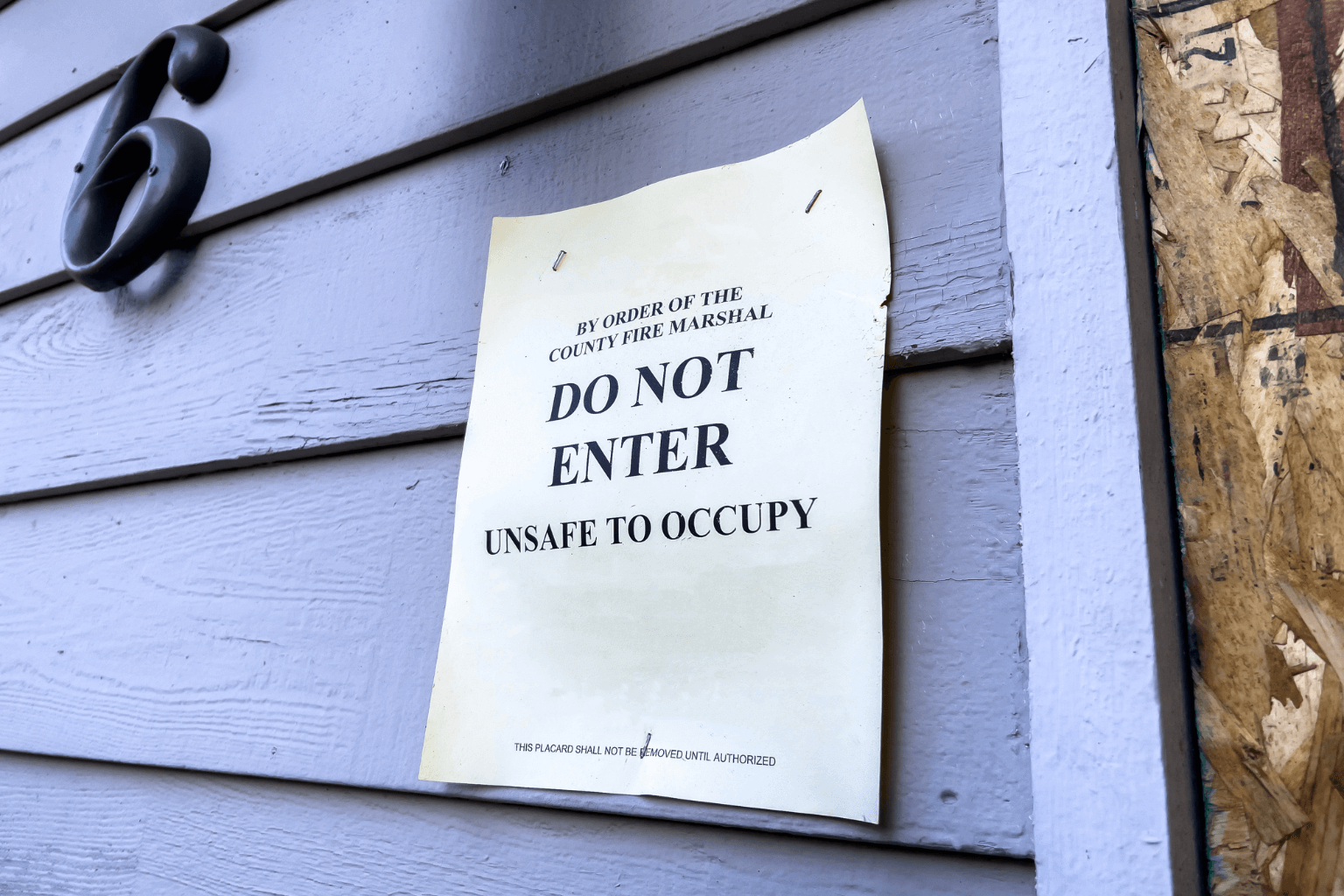 Condemned sign posted on a locked gate of private property