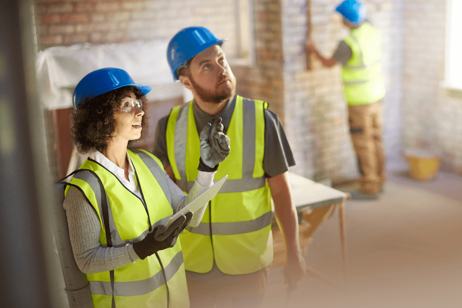 Contractor working on home repairs with clipboard and tools