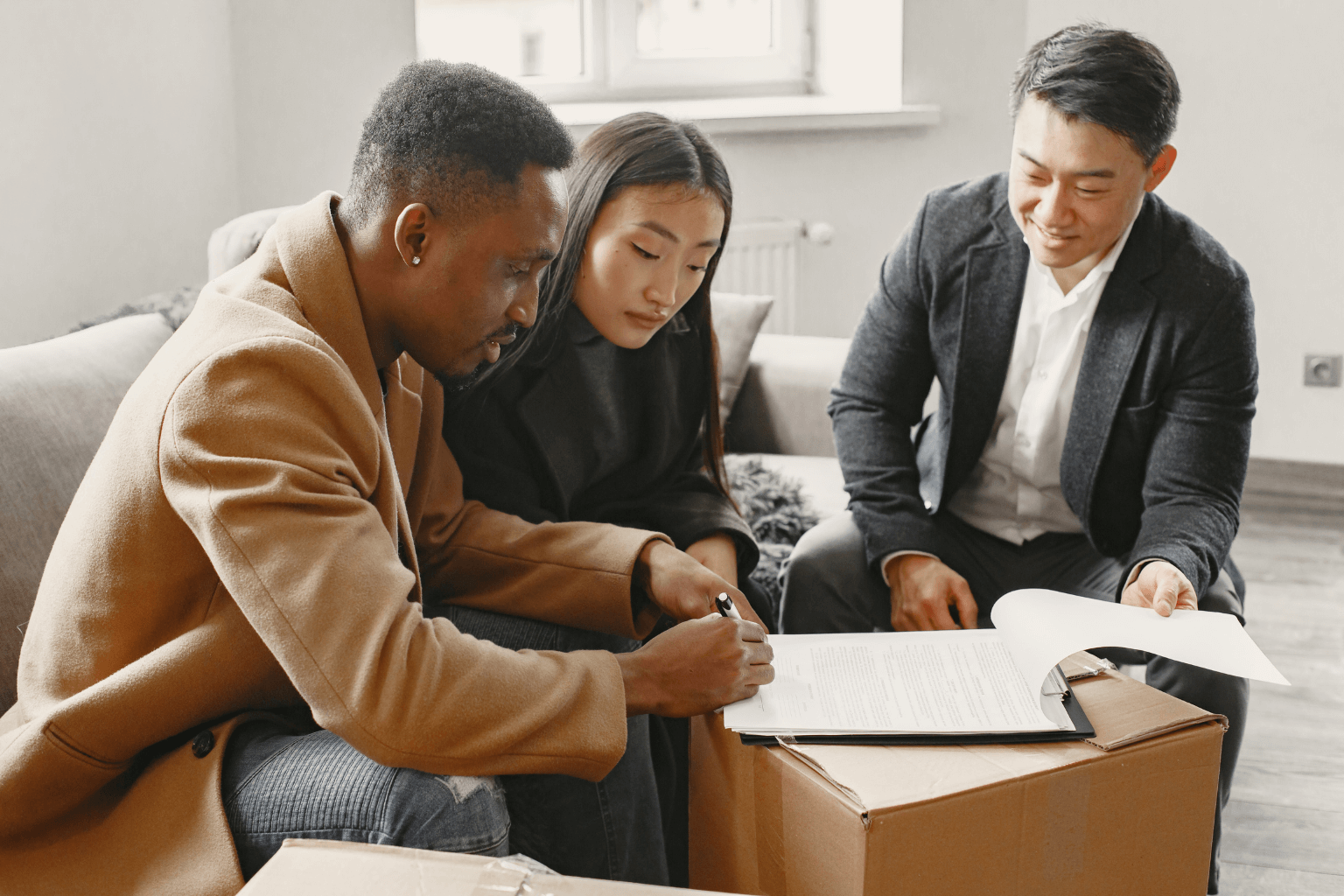 Divorcing couple signing house sale agreement