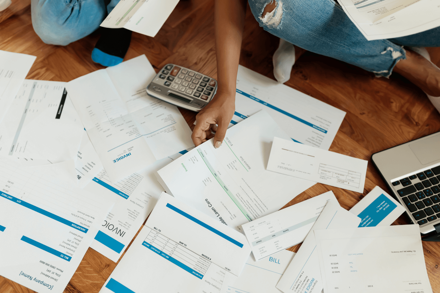 Person reviewing home-related debts and financial paperwork