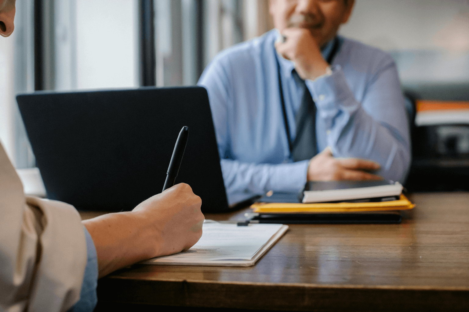 Person completing property registration forms with assistance