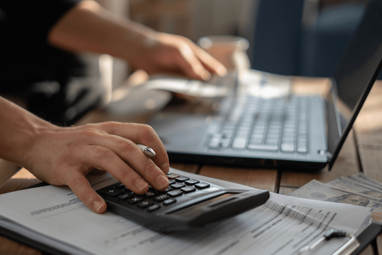 Homeowner reviewing financial documents and calculator for repair costs