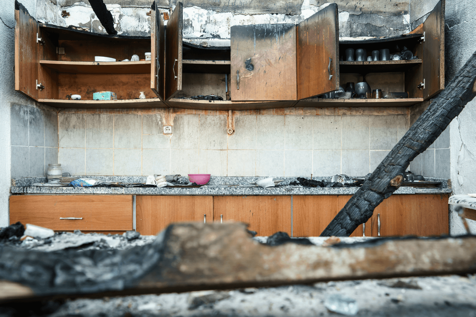 Interior room with fire-damaged ceiling and walls
