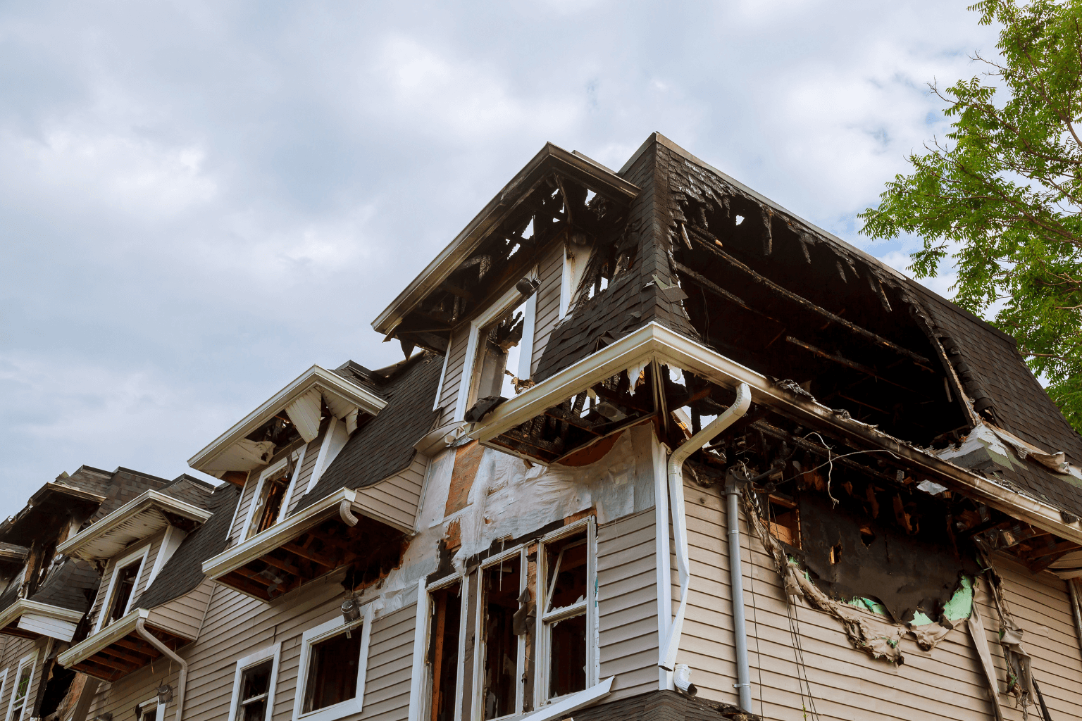 Exterior of a fire-damaged house with visible burn marks