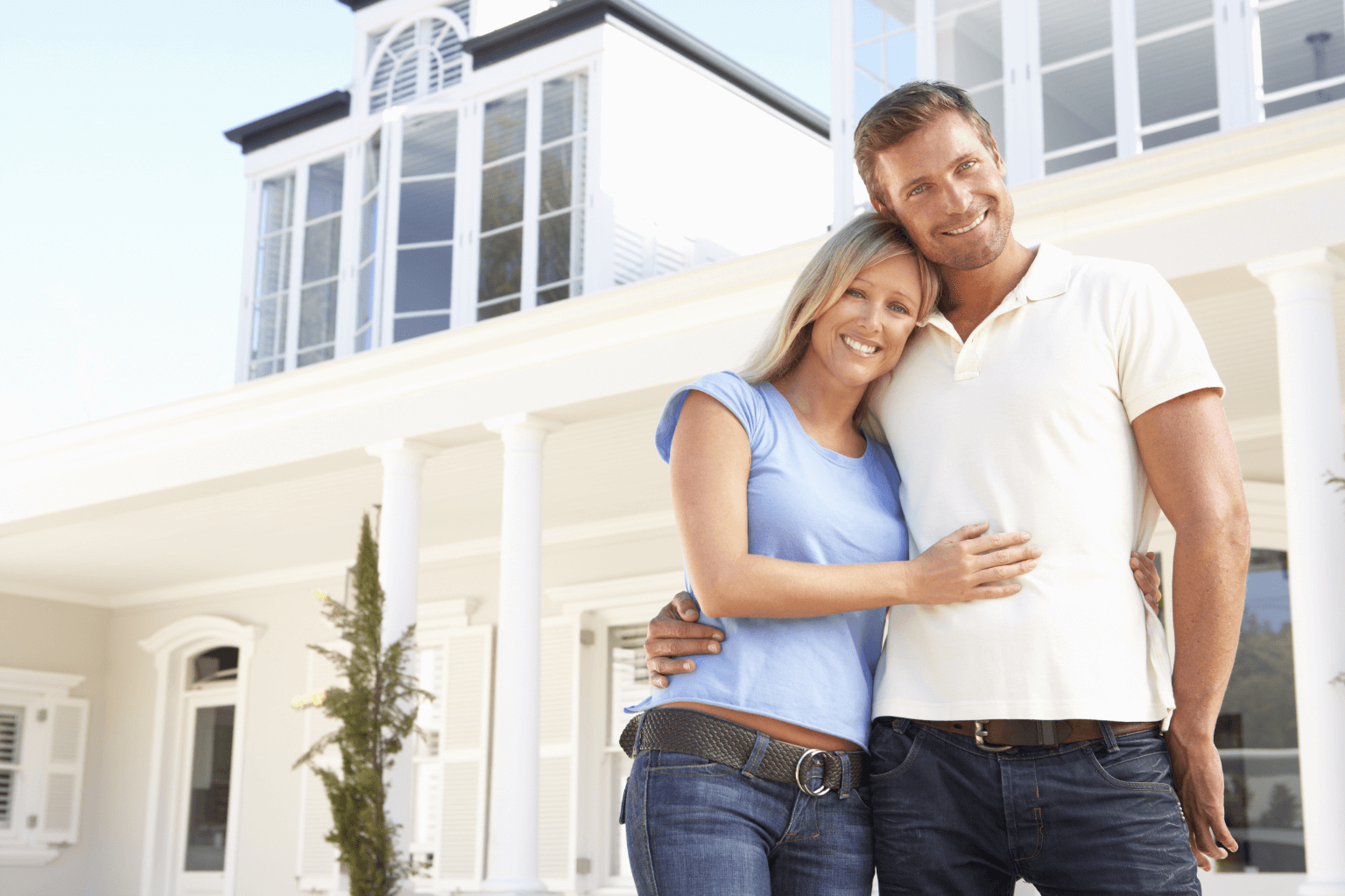 Happy homeowner smiling outside their house after a quick sale