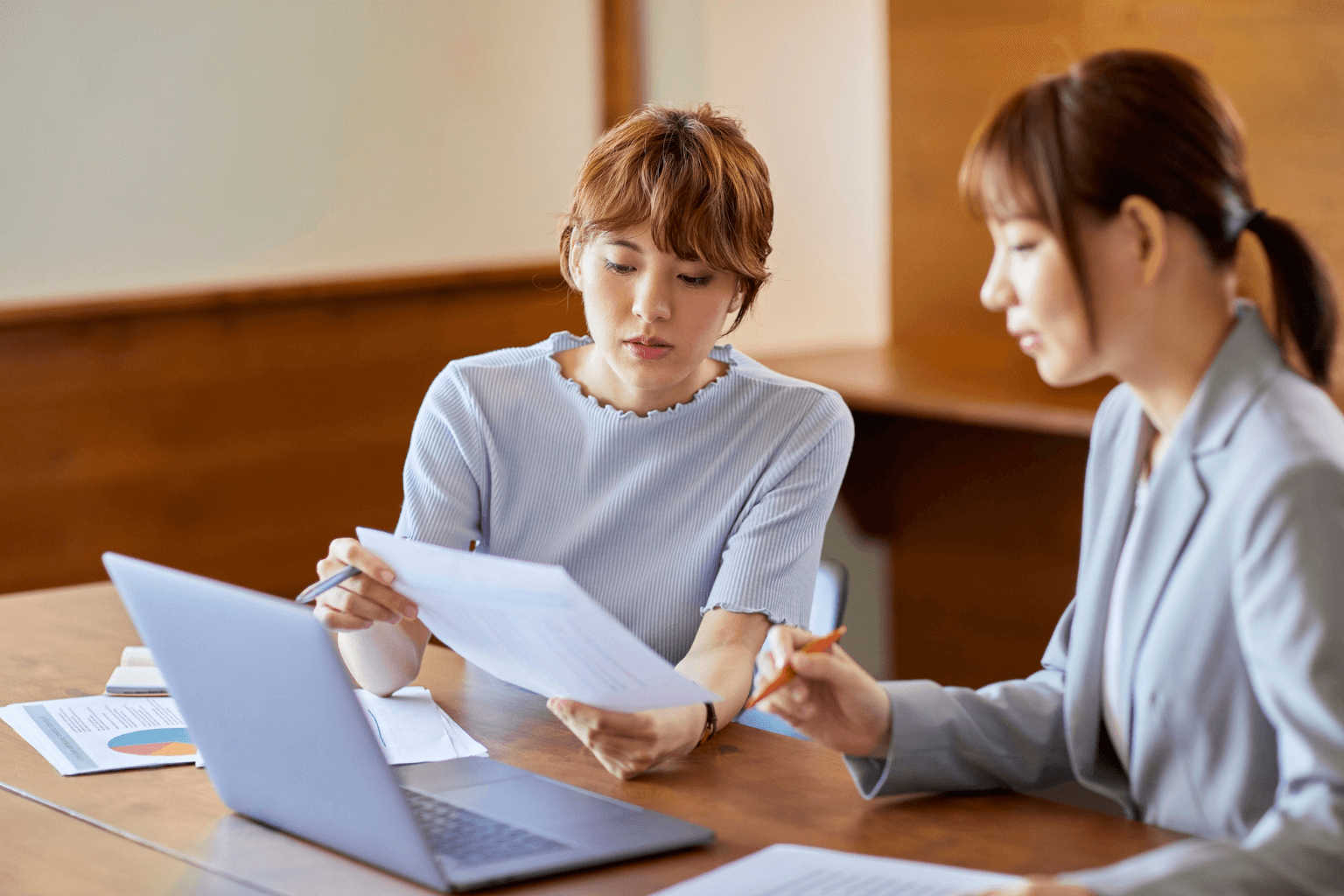 Seller and buyer discussing home repairs over paperwork
