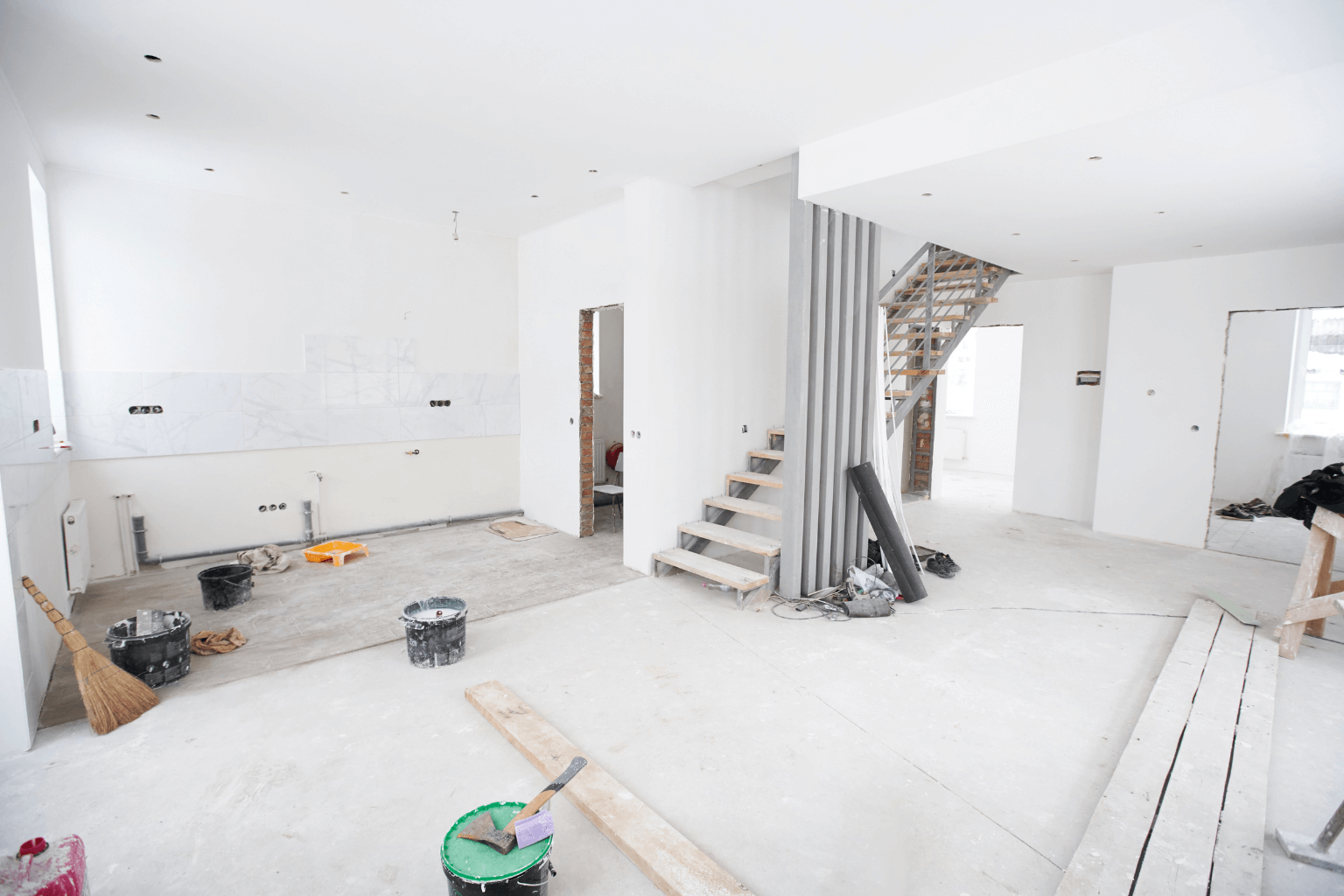 Unfinished room with exposed wiring and construction materials