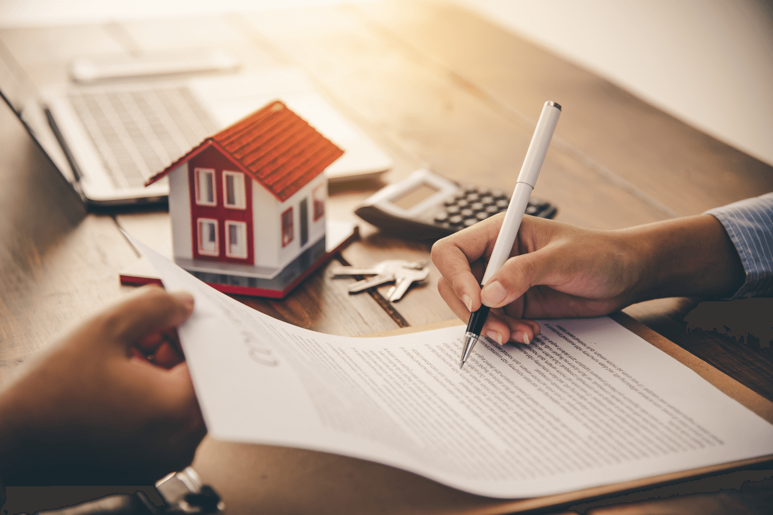 Signing paperwork to finalize home sale