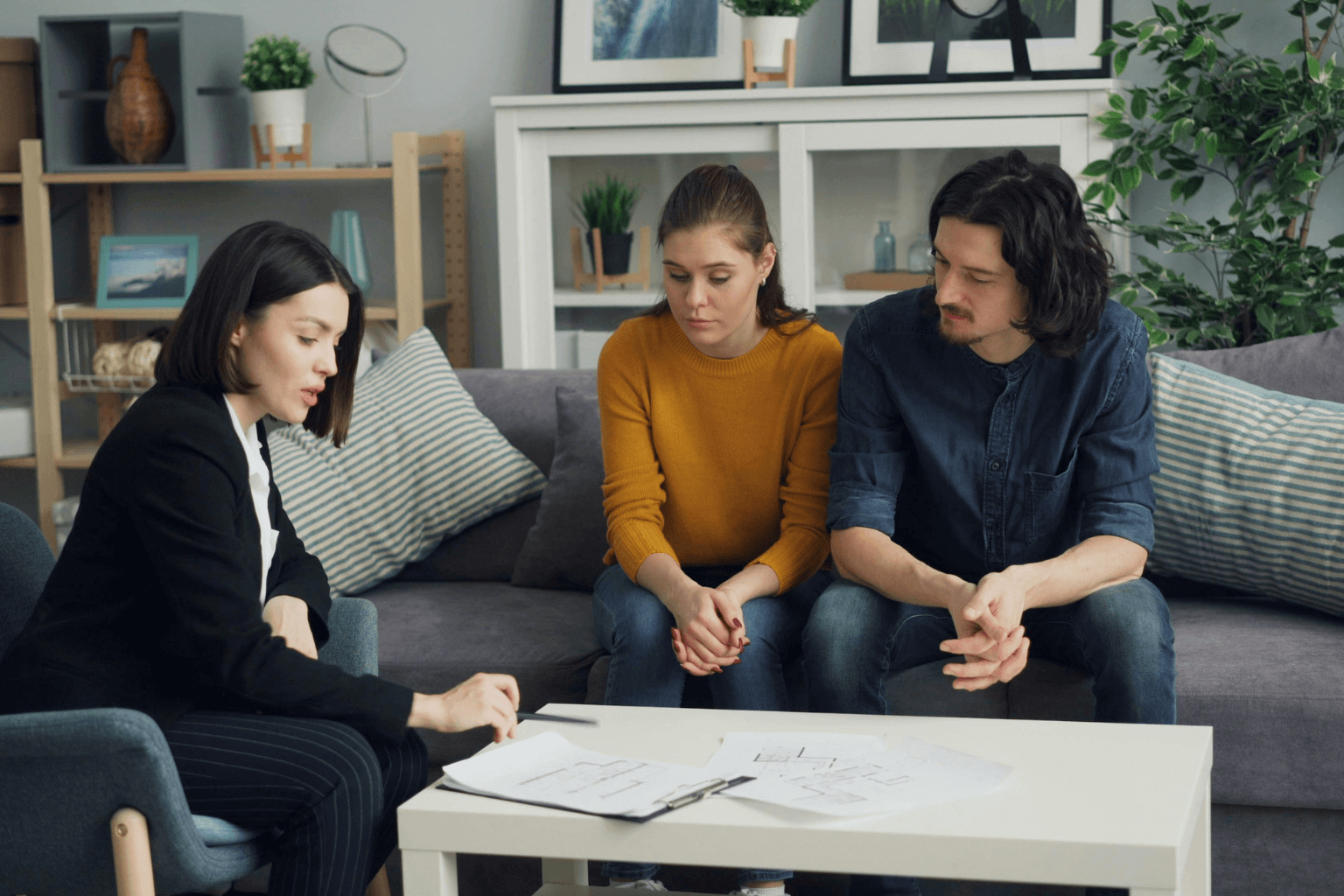 Real estate agent discussing home value with a couple