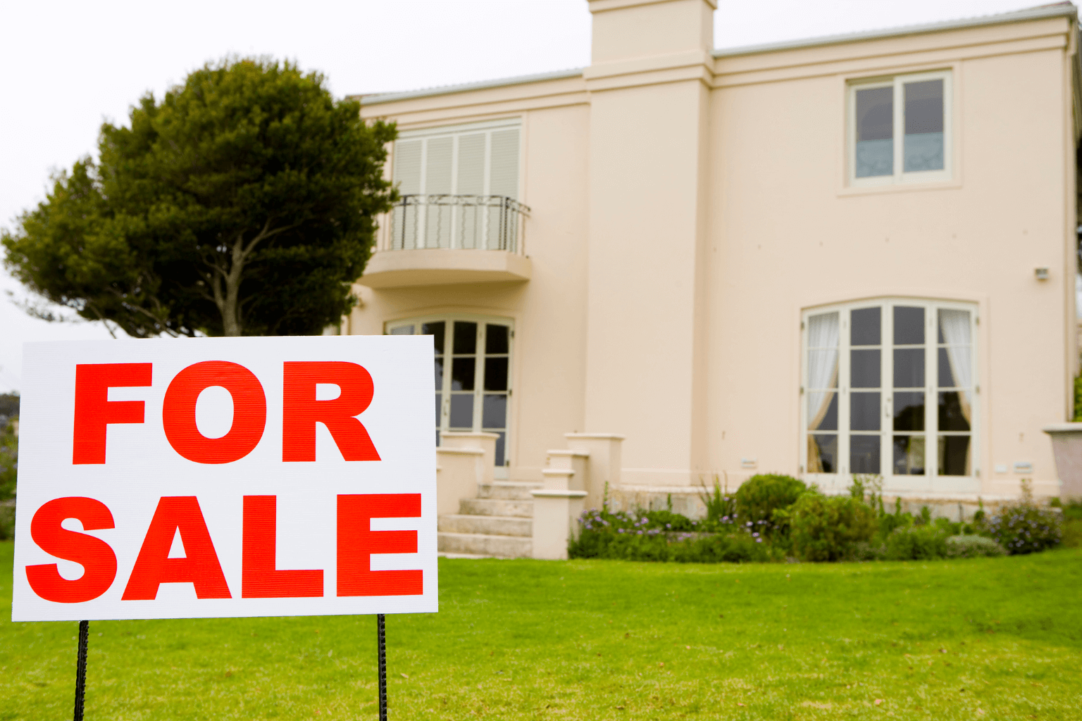 House for sale with a sign in the front yard