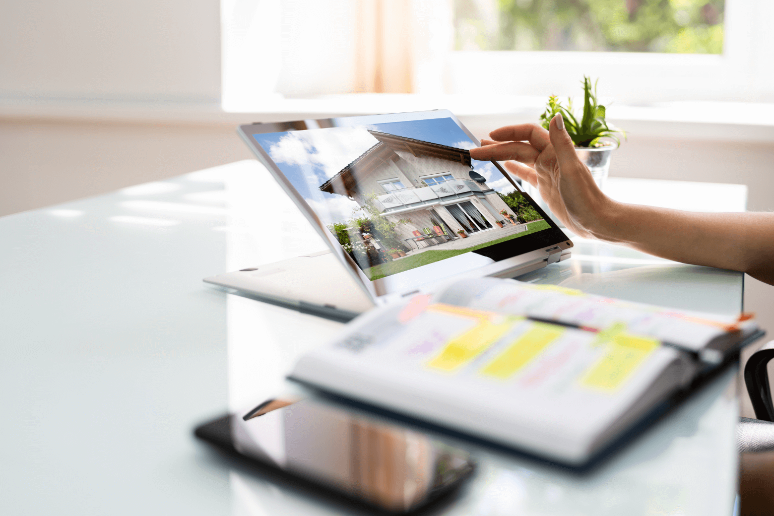 Laptop showing house listing for online real estate marketing