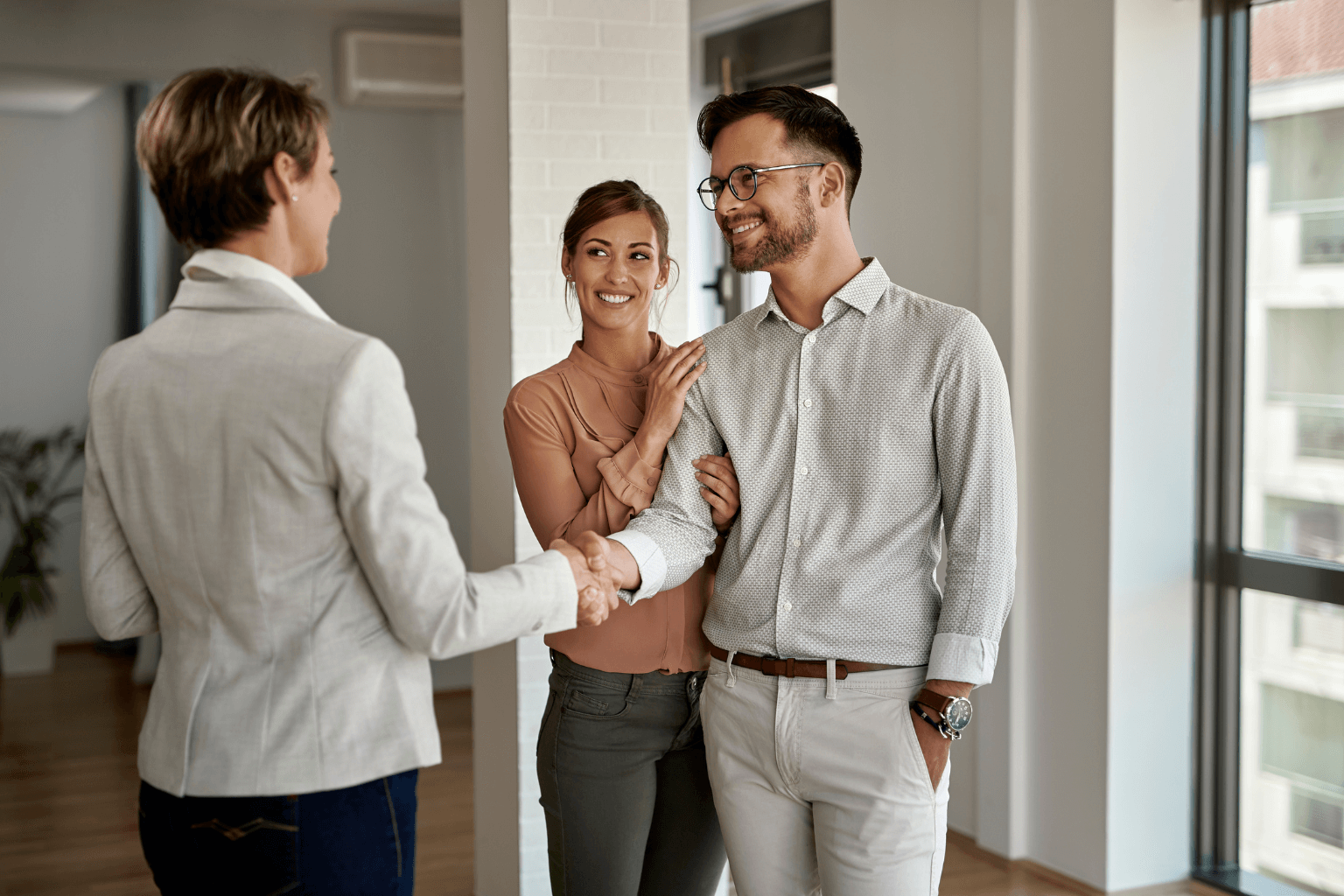 Real estate agent shaking hands with a homeowner