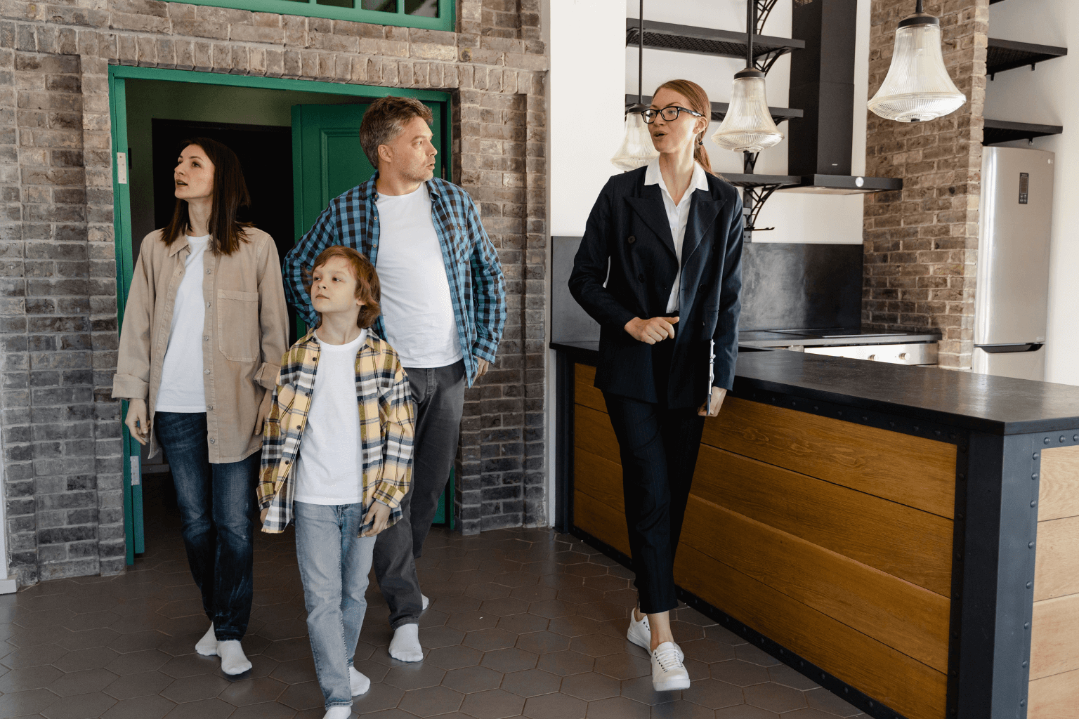 Real estate agent showing a renovated house to buyers