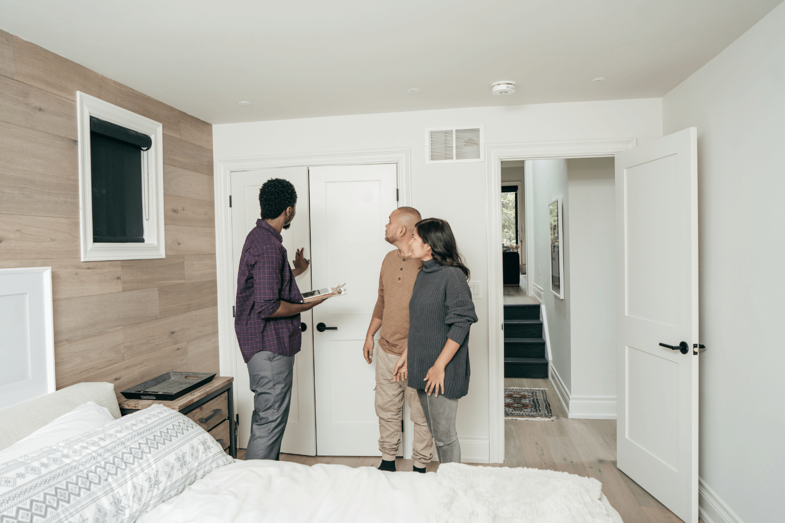 Real estate agent discussing sale with clients in a home