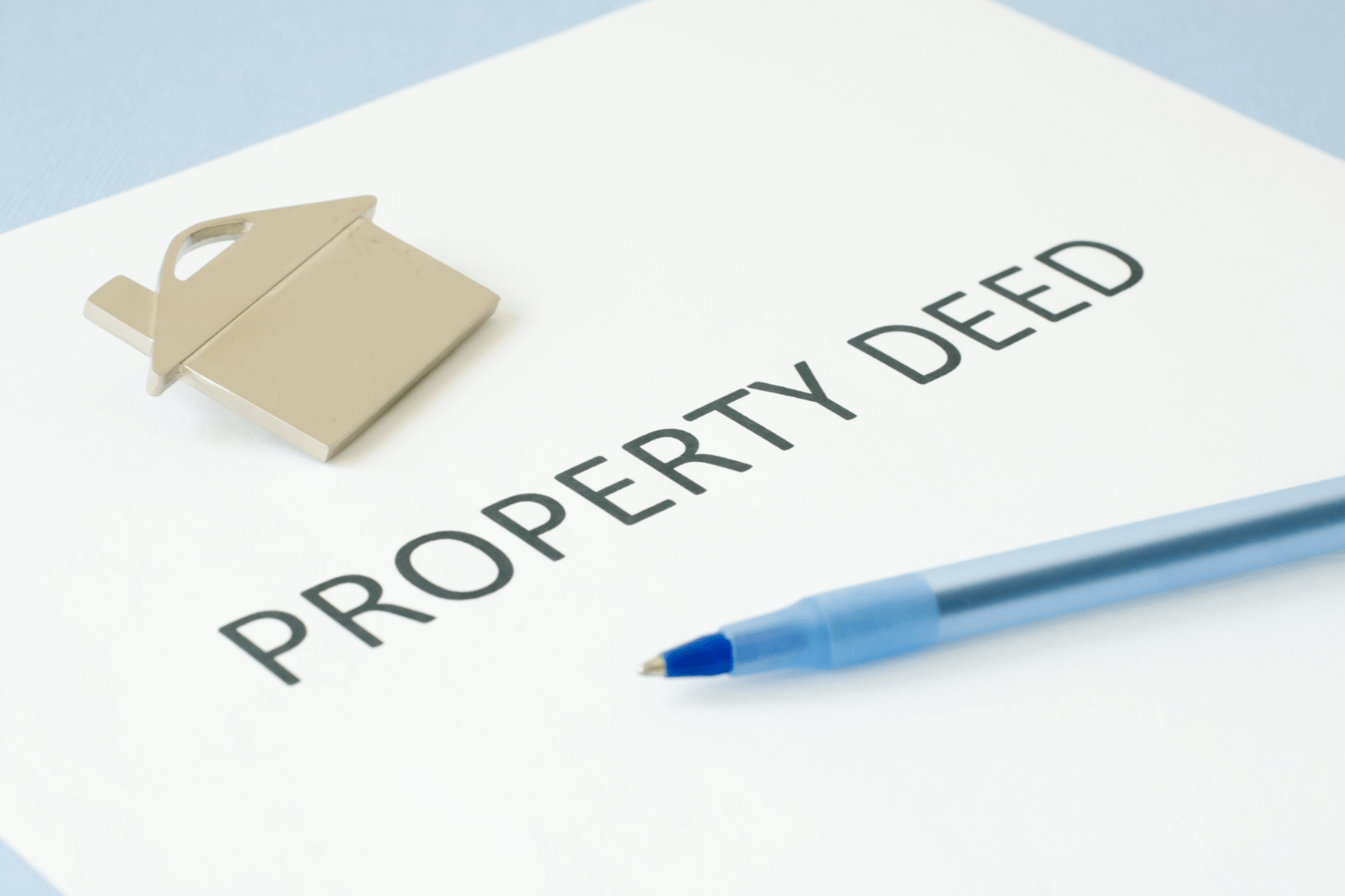 Close-up of real estate documents and a pen on a table