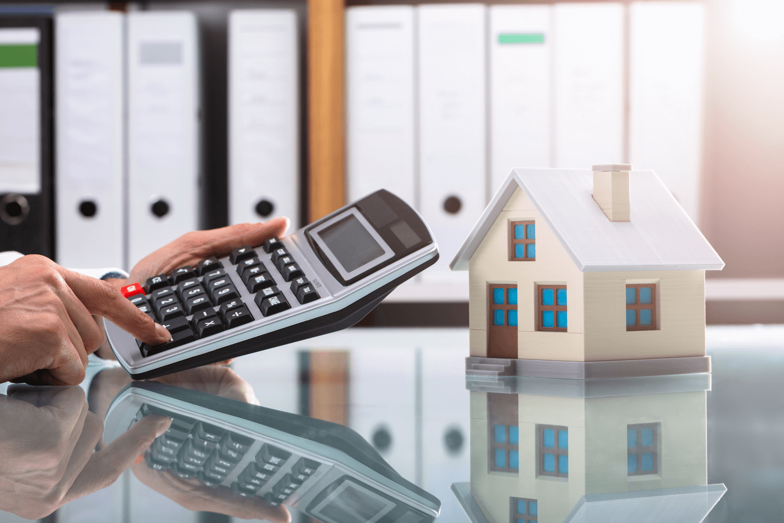 Real estate agent calculating home sale price