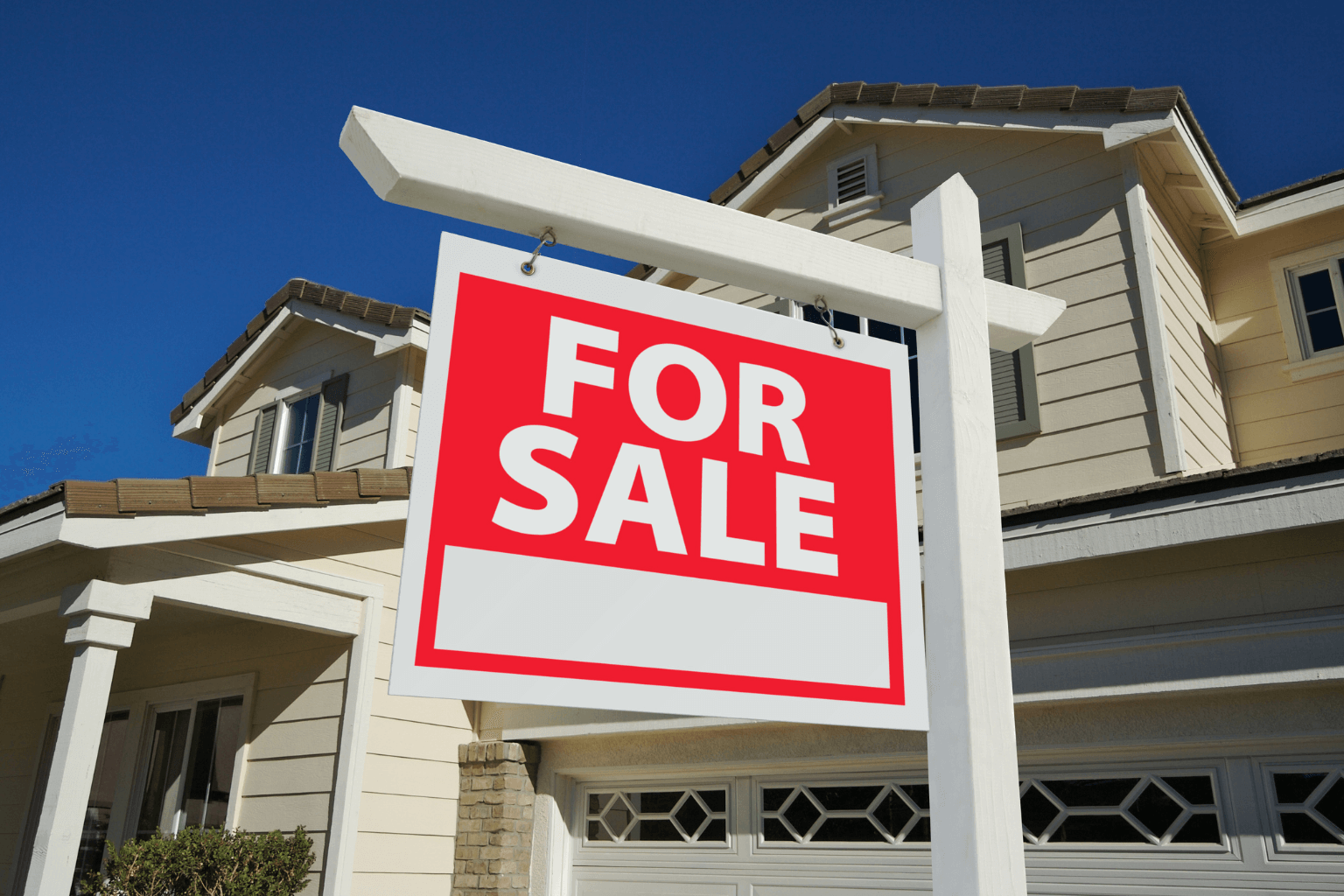 Exterior of a home for sale with a "For Sale" sign