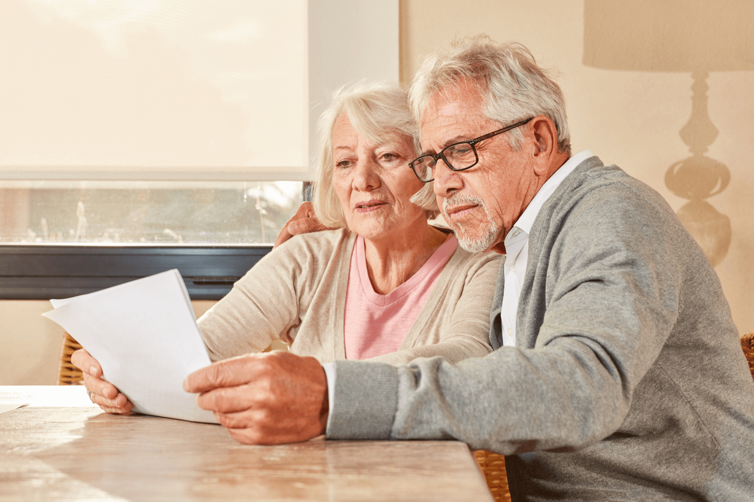 Senior couple reviewing reverse mortgage documents at home