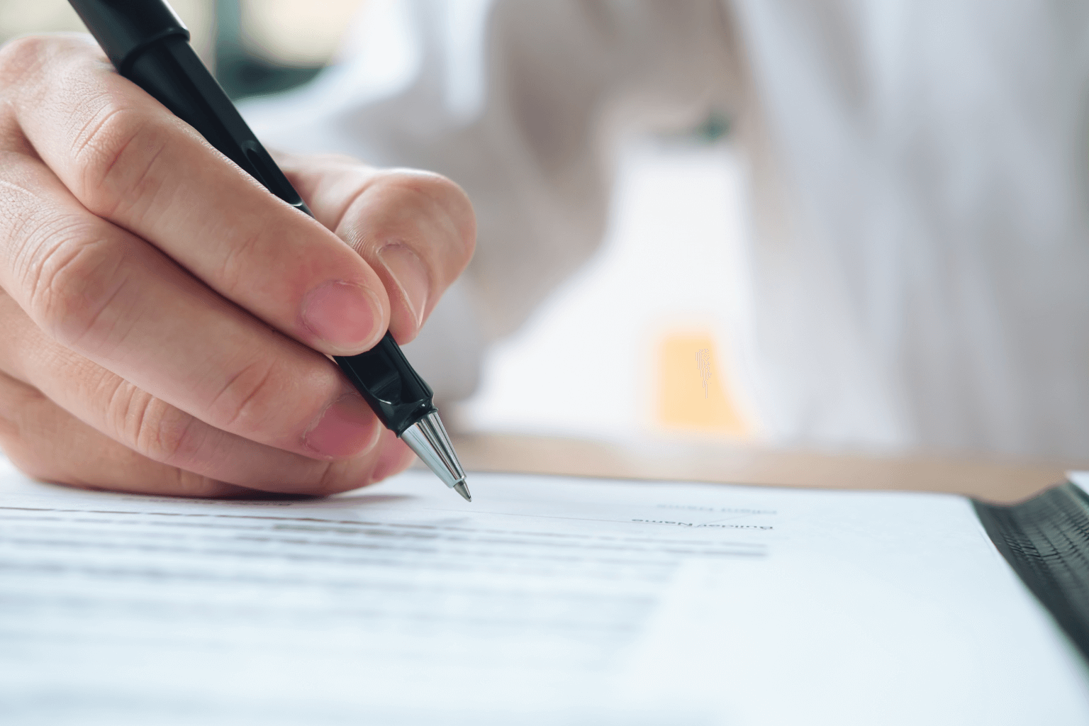 Person signing legal documents for property compensation