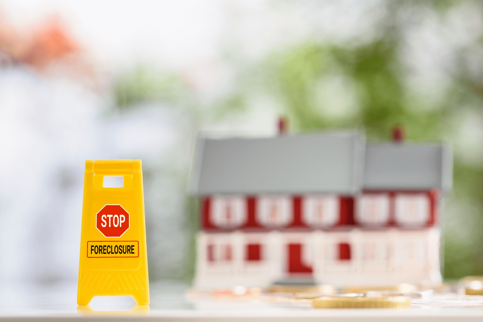 Stop foreclosure sign in front of a California house model