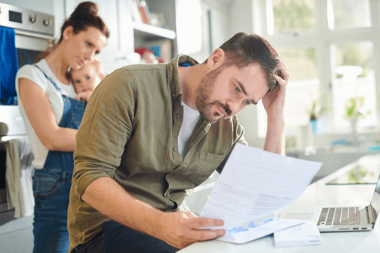 A worried California homeowner reviewing mortgage documents