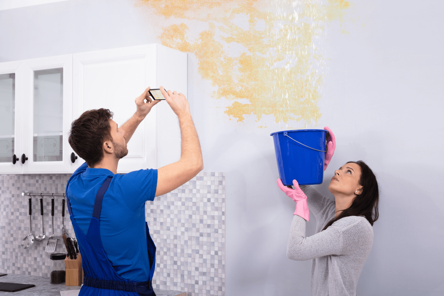 Someone taking pictures of water damage inside a house