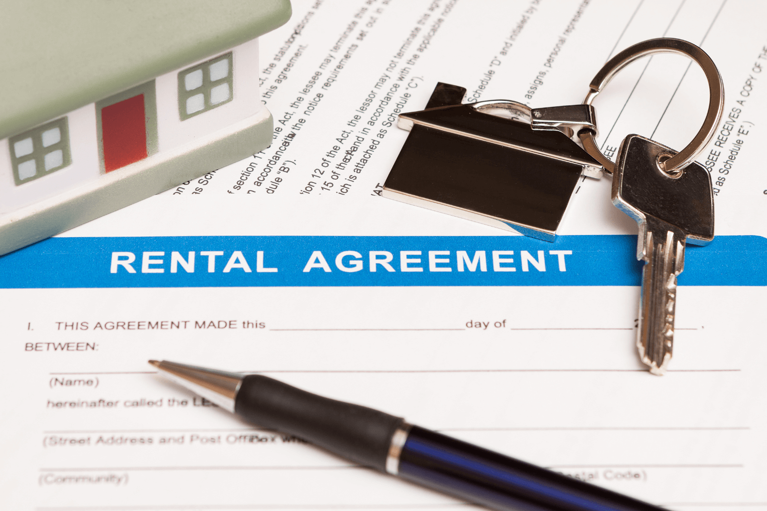 Rental agreement with pen and legal documents on desk