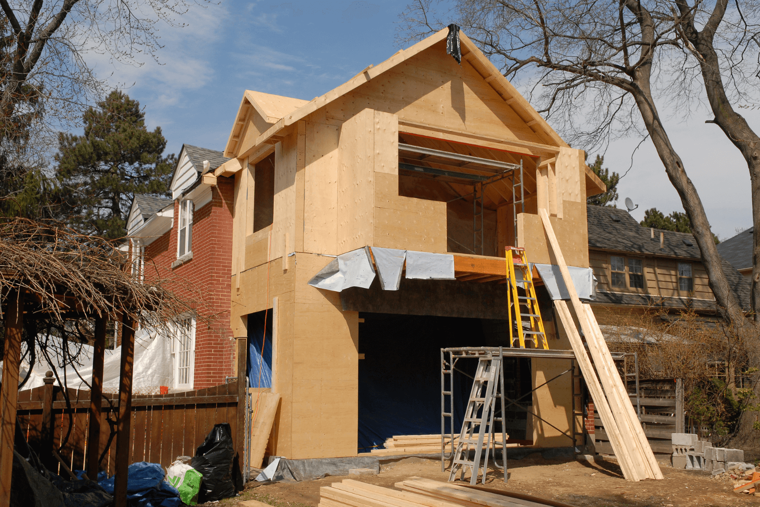 House with visible DIY renovations and tools outside