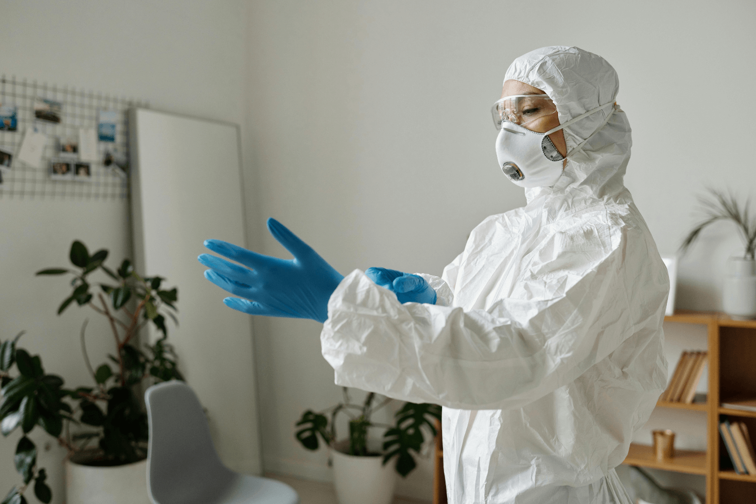 How To Sell a House With Hoarding Conditions Legally Worker wearing protective gear during home cleanup