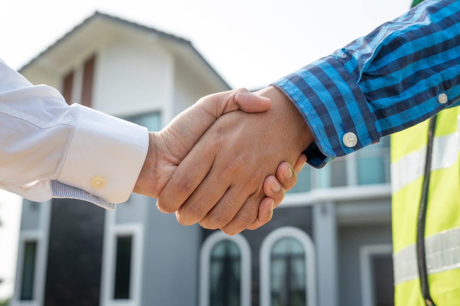 Cash Home Buyers in California shaking hands outside a house