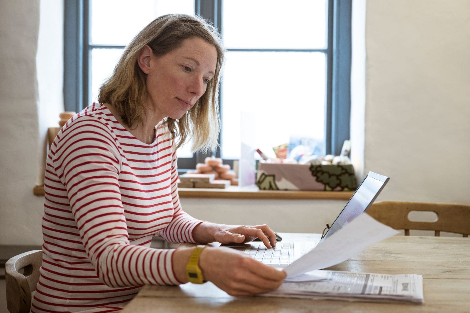 Can You Sell a Home After a Notice of Default in California Person reviewing paperwork at a table