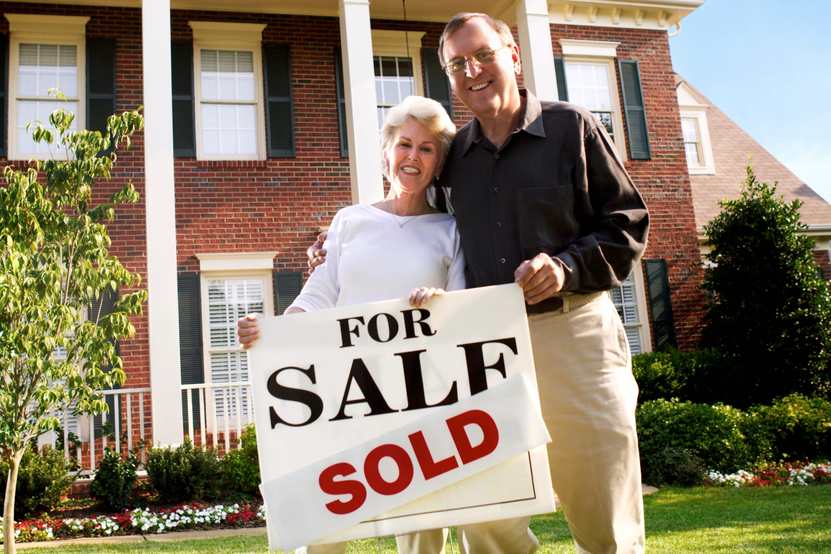 happy home seller holding a "sold" sign | Proposition 19