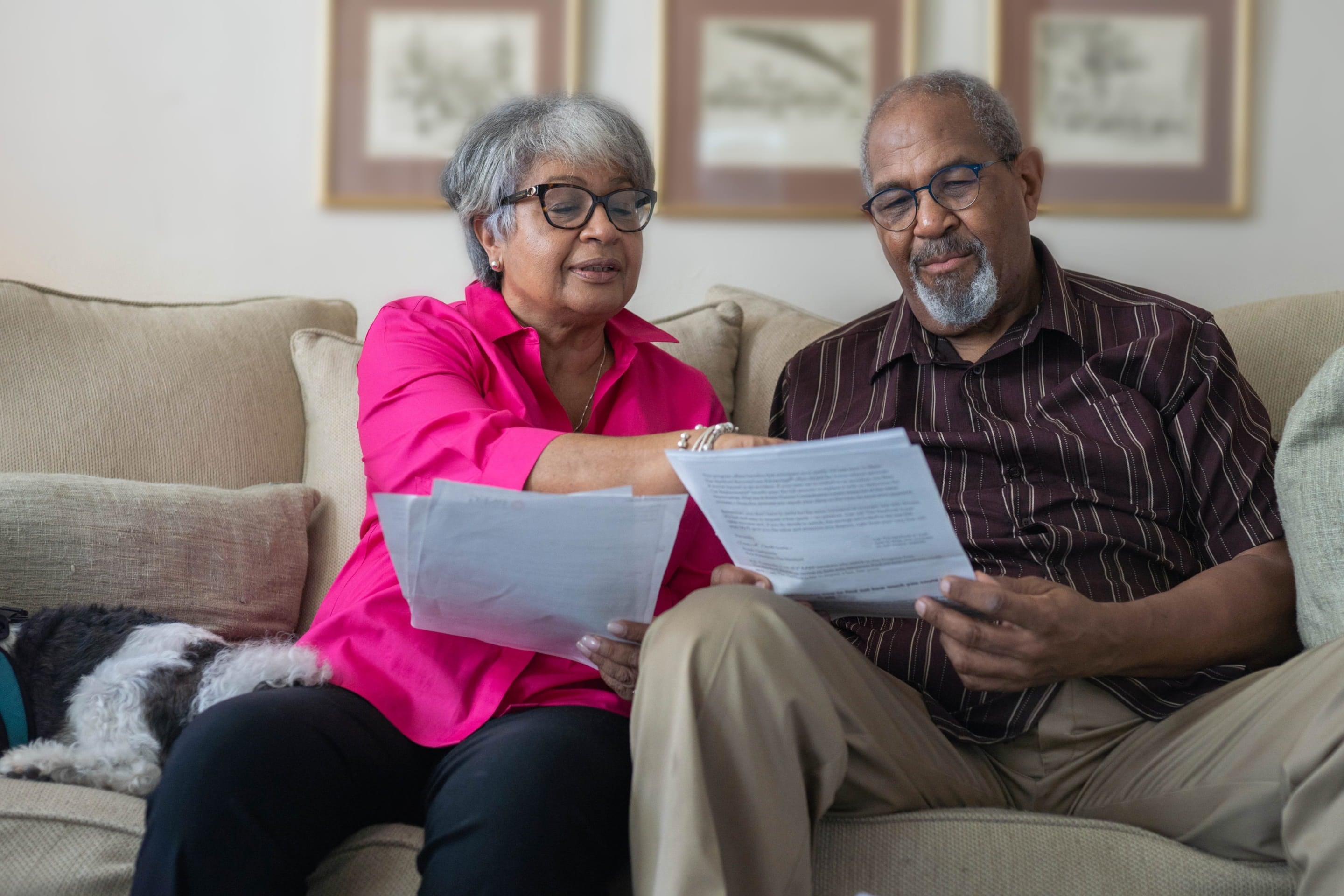 Homeowner reviewing paperwork in the living room | Proposition 19