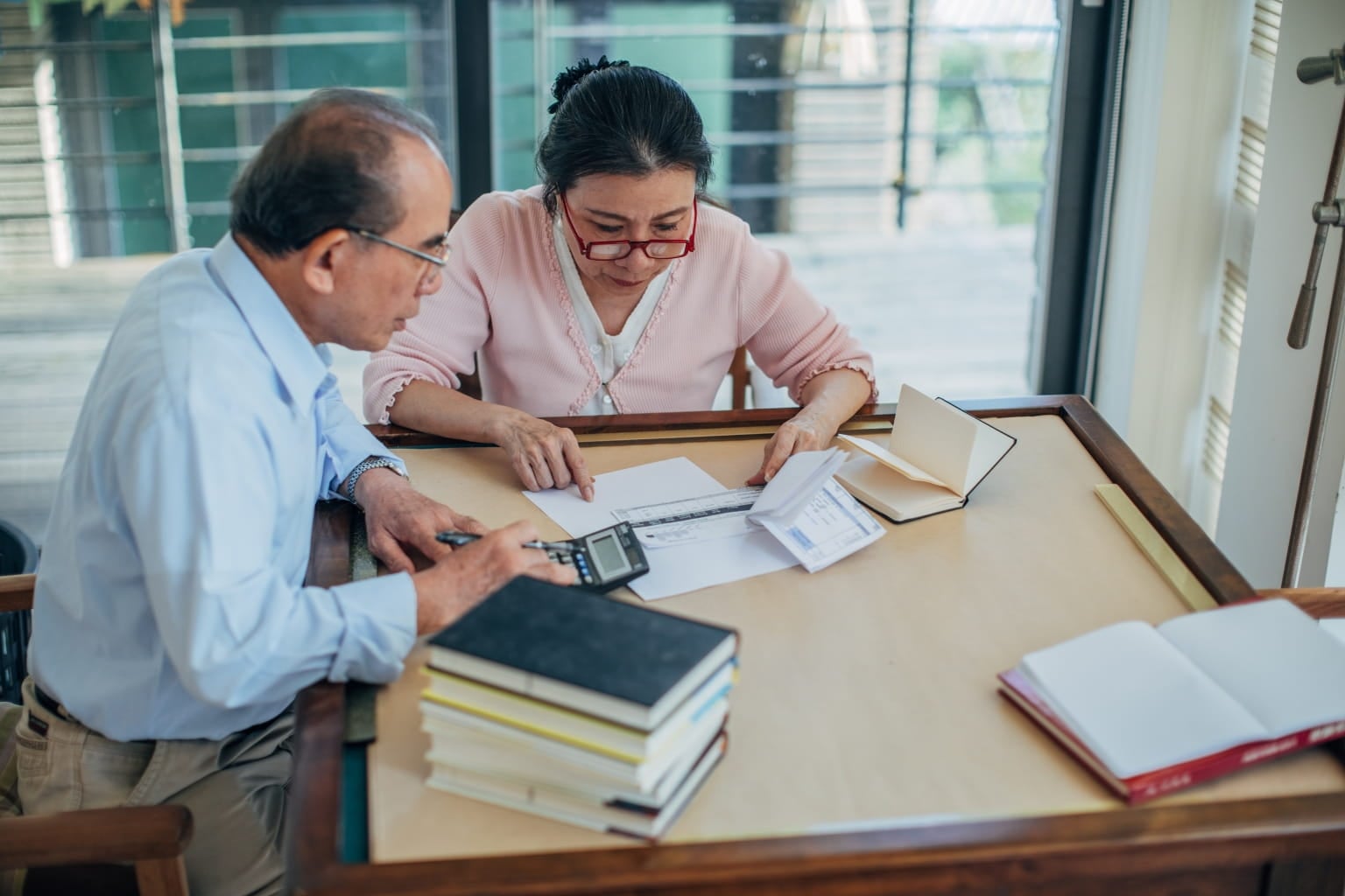 sitting at table reviewing financial paperwork