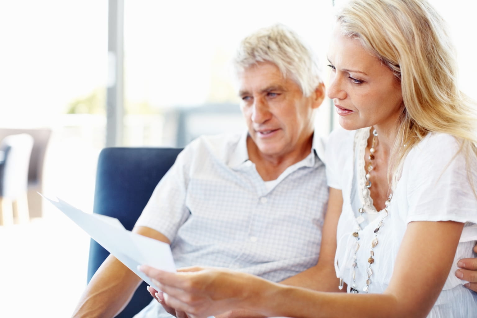 Couple discussing paperwork at table