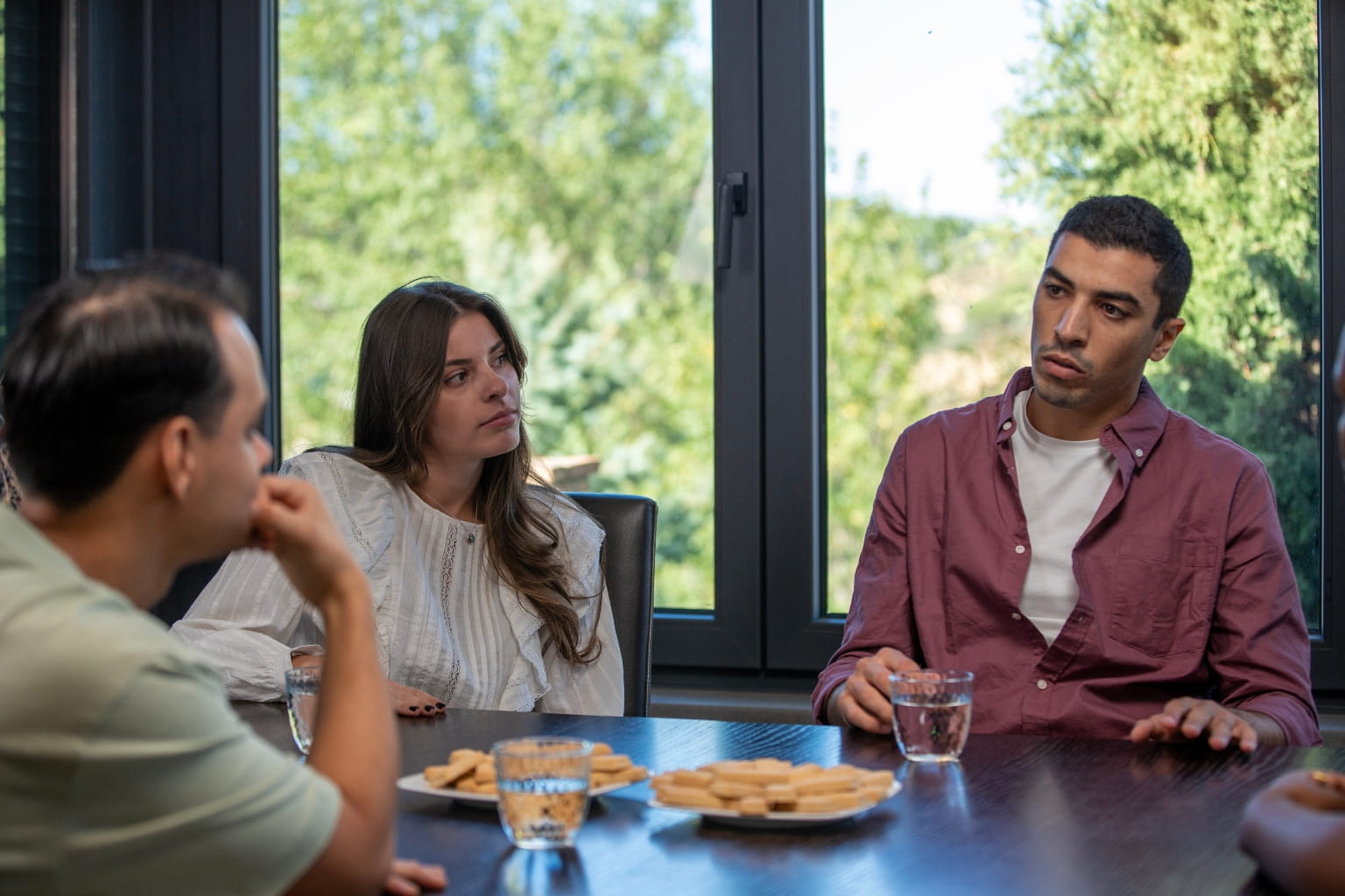 family holding a discussion around a table | How to Handle Inheritance Disputes