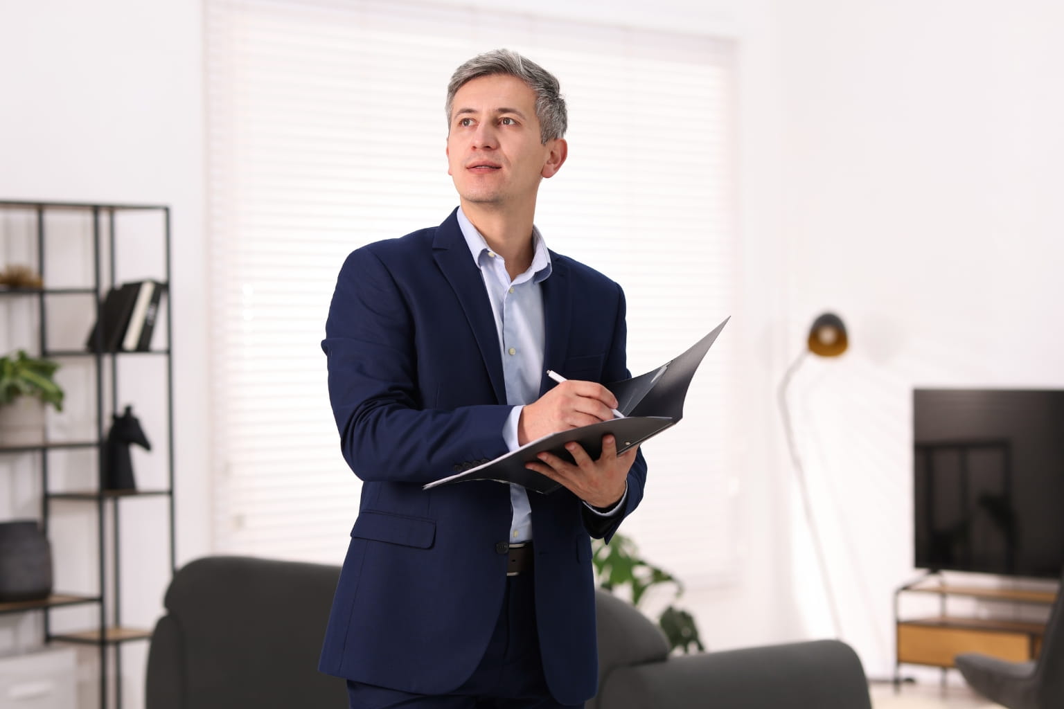 Real estate professional inspecting a home for valuation