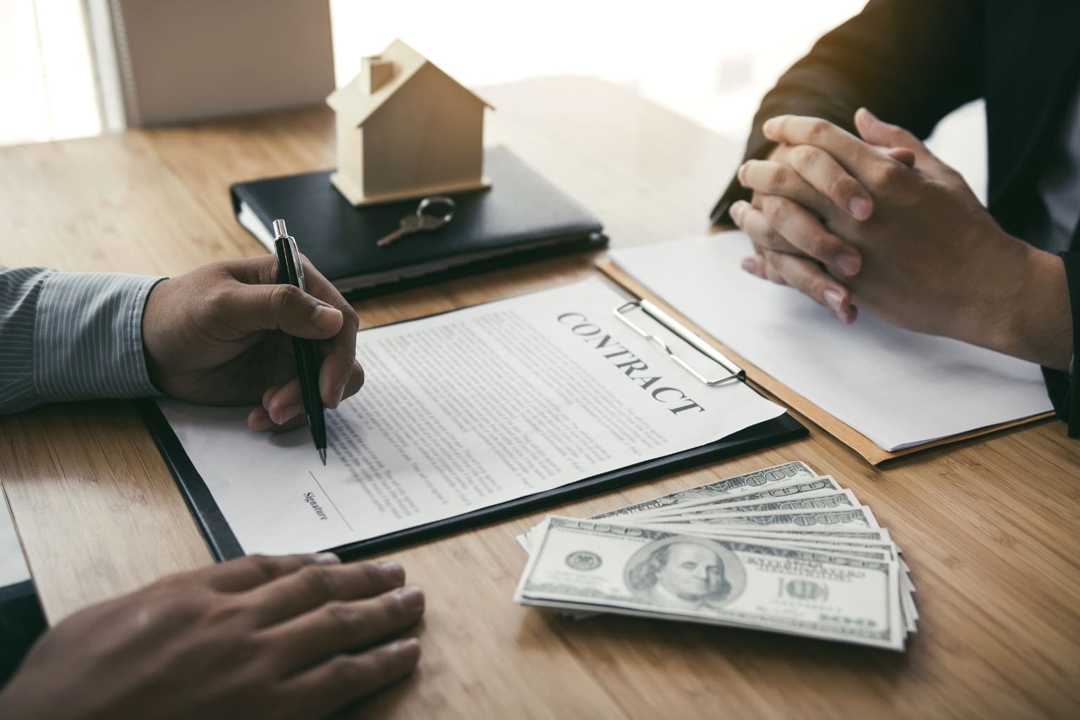 How to Sell a Home Fast When Downsizing or Retiring in California signing documents during home closing process