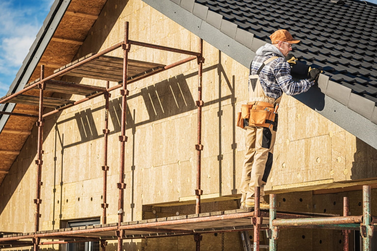 Worker renovating a home with new roof