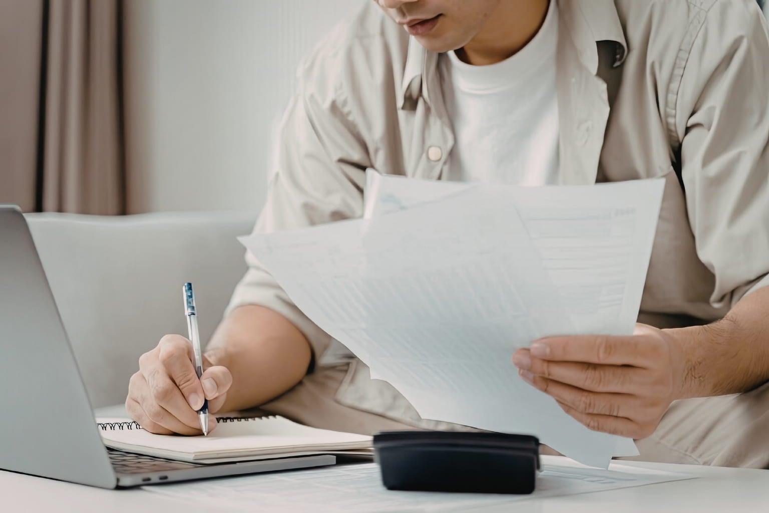 a man at a table reviewing docuemnts